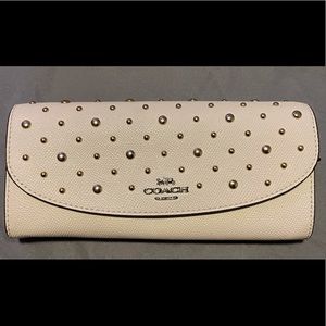 Coach cream/ivory studded flap style wallet